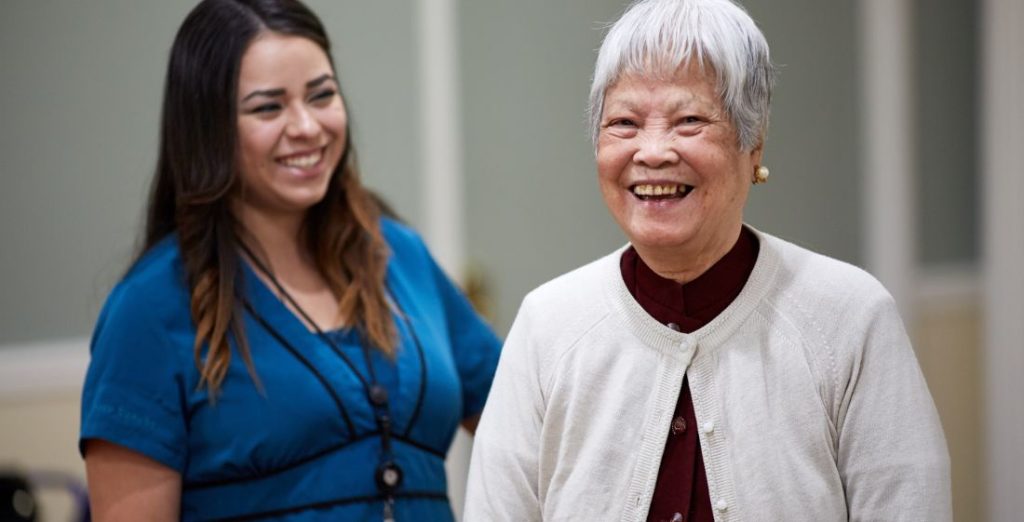 Care partner and resident smiling 1