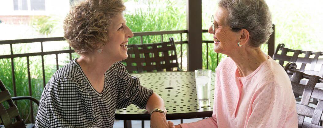 Holly Creek resident and daughter talking on patio