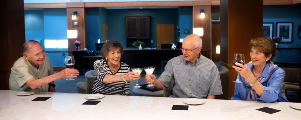 Holly Creek residents raising their glasses at entryway bar