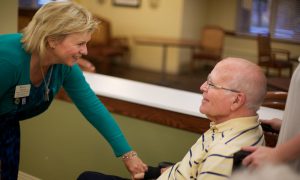 Resident and care partner talking and smiling