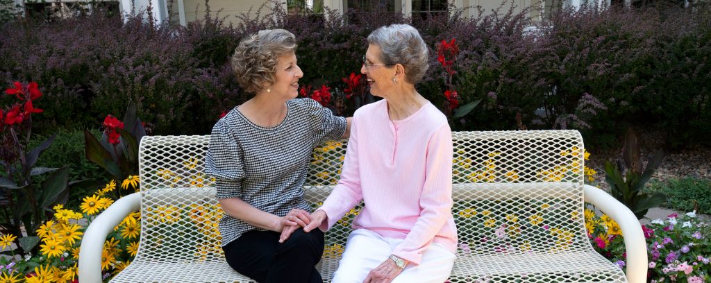 Resident and her daughter talking in courtyard