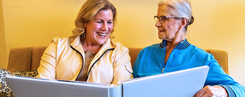 Resident and loved one looking through photo book