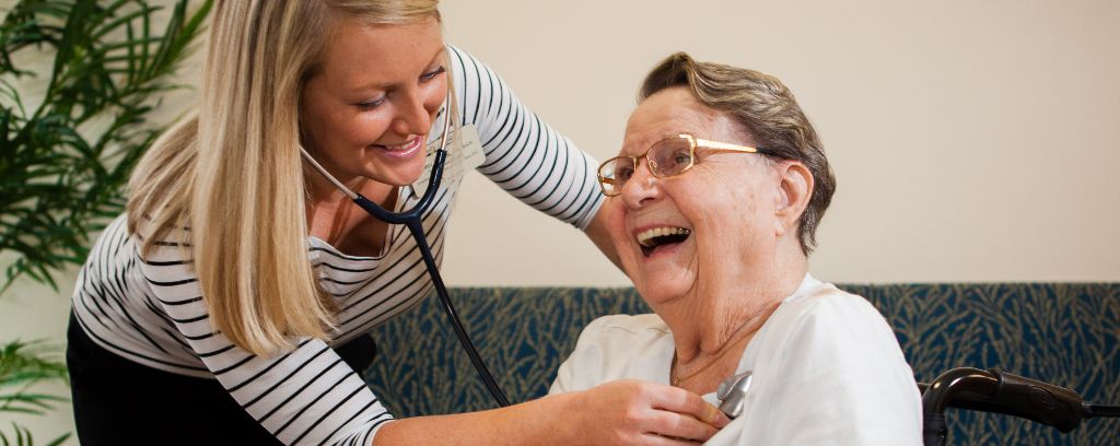 Team member listening to residents heart beat