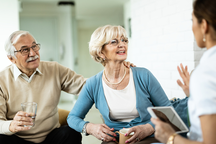 senior couple talking to professional