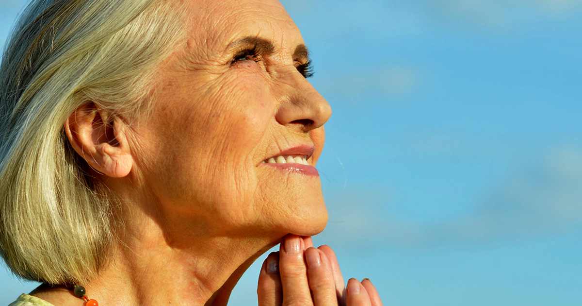 Woman enjoying sunrise.