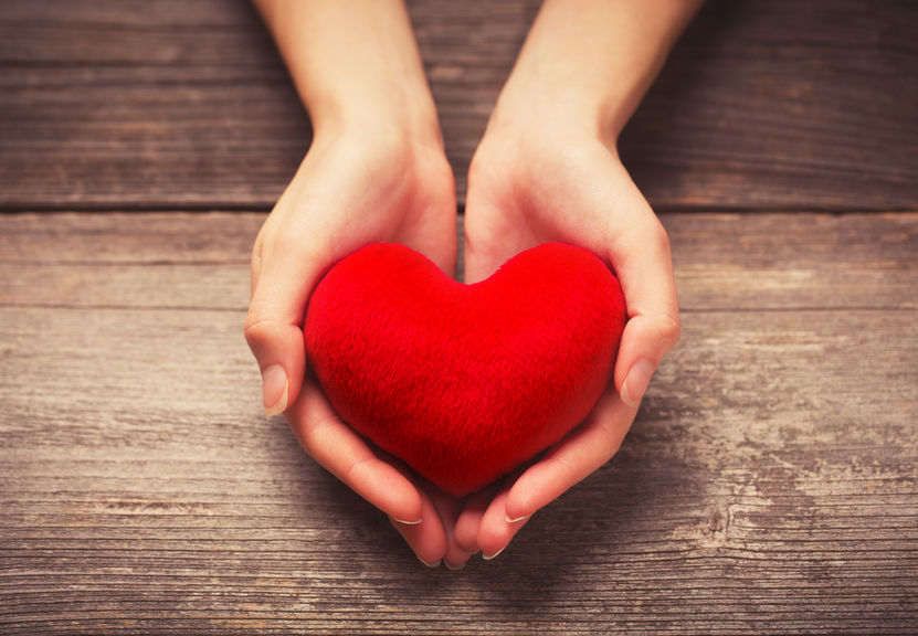 Female hands giving red heart