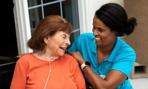 Care partner and resident smiling