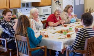 Residents and team members talk over cider