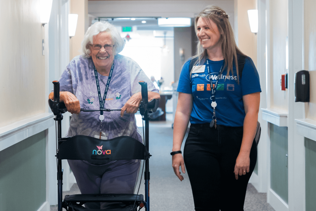 Resident and team member walking down hallway