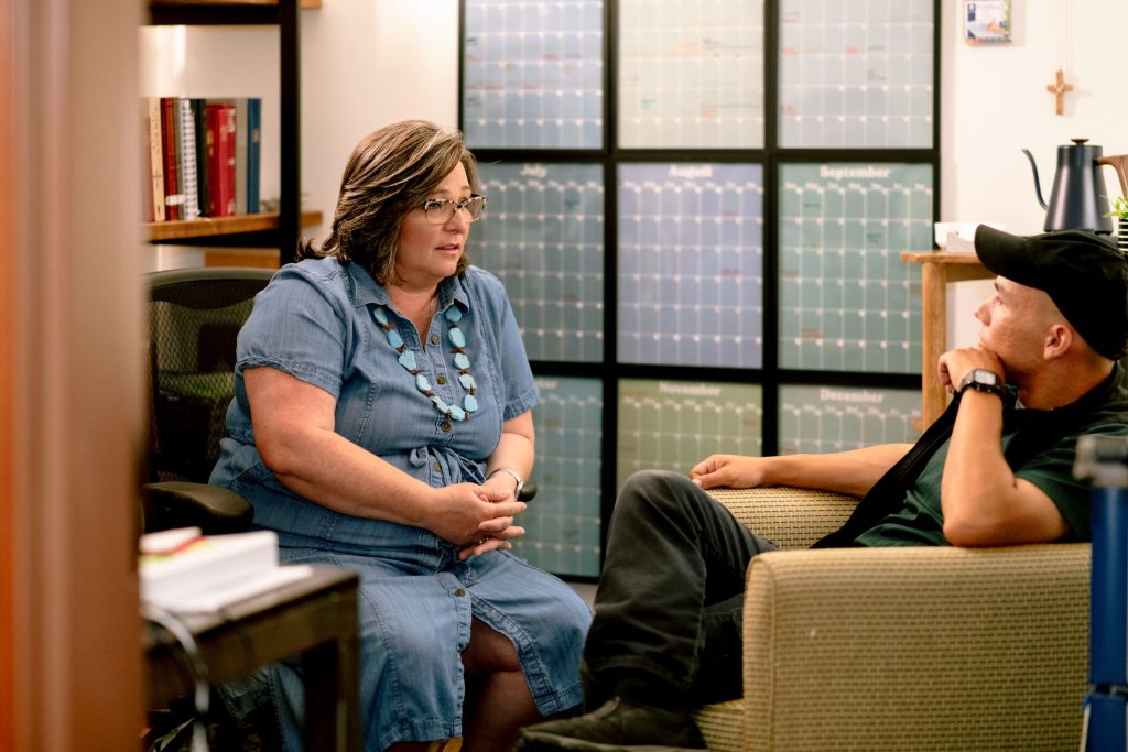 chaplain and team member talking