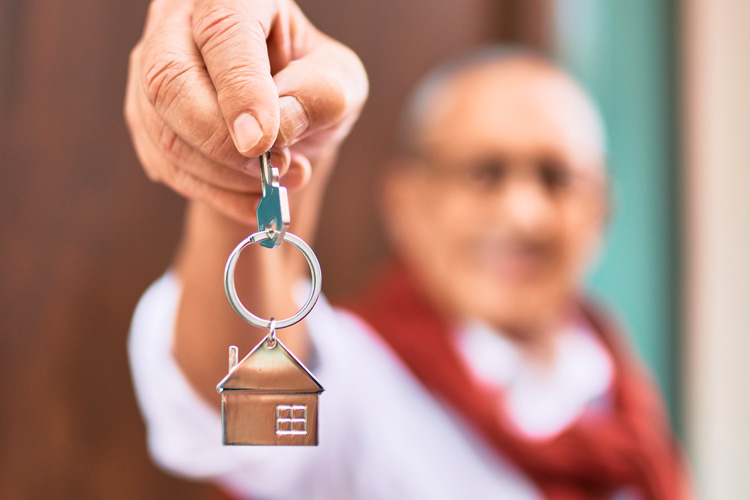 cappella digital marketing solutions close up of house key held by senior man
