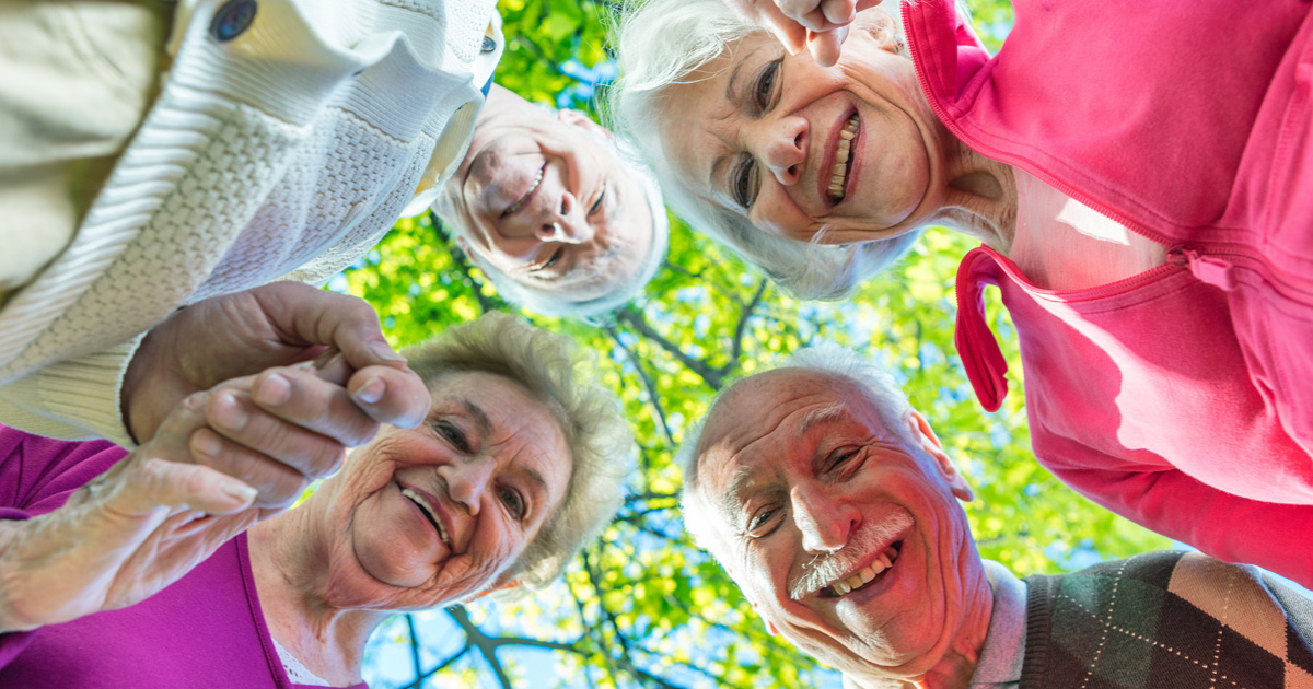 cappella digital marketing solutions group of happy seniors in a circle looking down cappella digital marketing solutions gears with marketing words